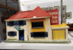 20th century doll's house with red roof and garage,