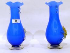 Pair of Murano blue cased vases with floral relief decoration,