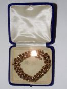 9ct gold double-curb link bracelet with safety chain, approx 22.