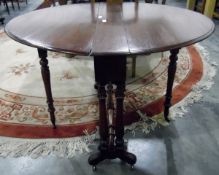 19th century oval mahogany Sutherland table with twin turned end standards and turned pole