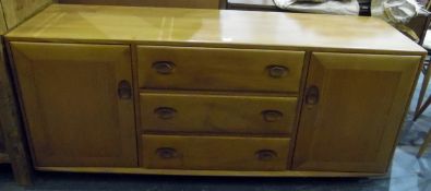 Ercol 1970's elm sideboard with three short drawers, flanked by pair cupboards,