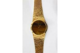 Lady's Bueche-Girod 9ct gold bracelet watch with the circular dial with circular tiger's eye quartz