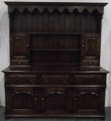 Georgian style oak dresser, the upper section having a dentil moulded cornice,