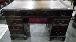 20th century mahogany pedestal desk with leather inset writing top, an arrangement of nine drawers,