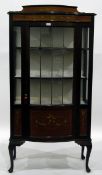 Edwardian mahogany china display cabinet enclosed by a bowed leaded glass panelled door,