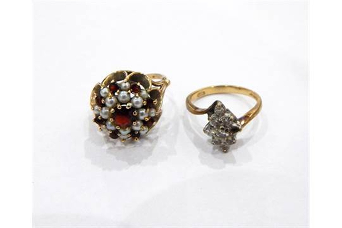 Gold, garnet and cultured pearl cluster ring and a 9ct gold crossover ring of blue stones,