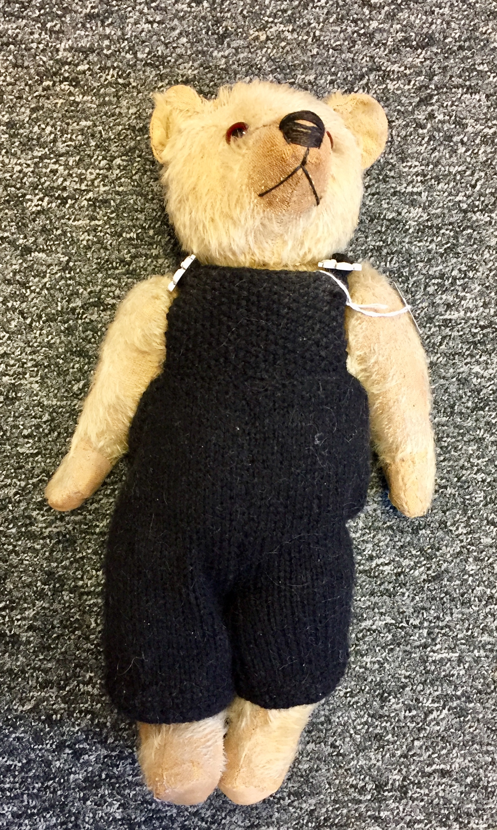 Antique mohair bear in black dungarees,