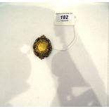 1898 half sovereign in gold foliate and pierced mount,