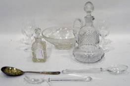 Cut glass wine jug with strawberry cut stopper and body, bulbous base, four small wine glasses,