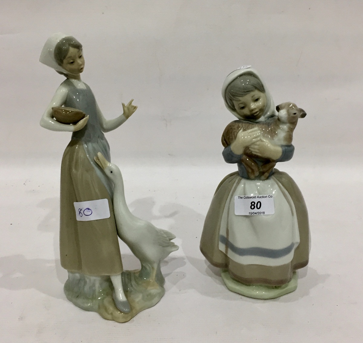 Lladro figure of a girl feeding a goose and a Spanish figure of a girl holding a lamb (2)