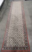 Belgian Kasbah wool runner of Persian design, the ivory field with allover herati design,