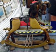 Wooden rocking horse with horse hair mane (has been cut) and tail, mounted on twin-pedestal support,