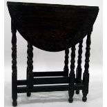 20th century oak drop-flap table, the carved top with turned supports united by stretchers,