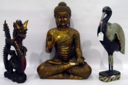 Modern model of Buddha on carved hardwood stand and two painted models of heron and dragon (4)