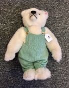 Steiff bear in green dungarees,