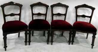 Set of four Edwardian mahogany dining chairs having carved shaped and moulded crest rails and