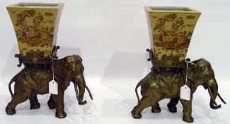 Pair of brass elephant models supporting ceramic planters,