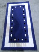 Pair blue and ivory rugs with rectangular and lozenge decoration,