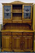 Pine dresser, the cupboards enclosed by leaded floral-style glass panelled doors,