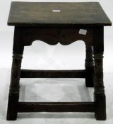 Late 19th century oak joint stool in revived Medieval style, having shaped and carved apron,