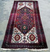 Eastern wool rug with six flowerheads to the midnight blue field,