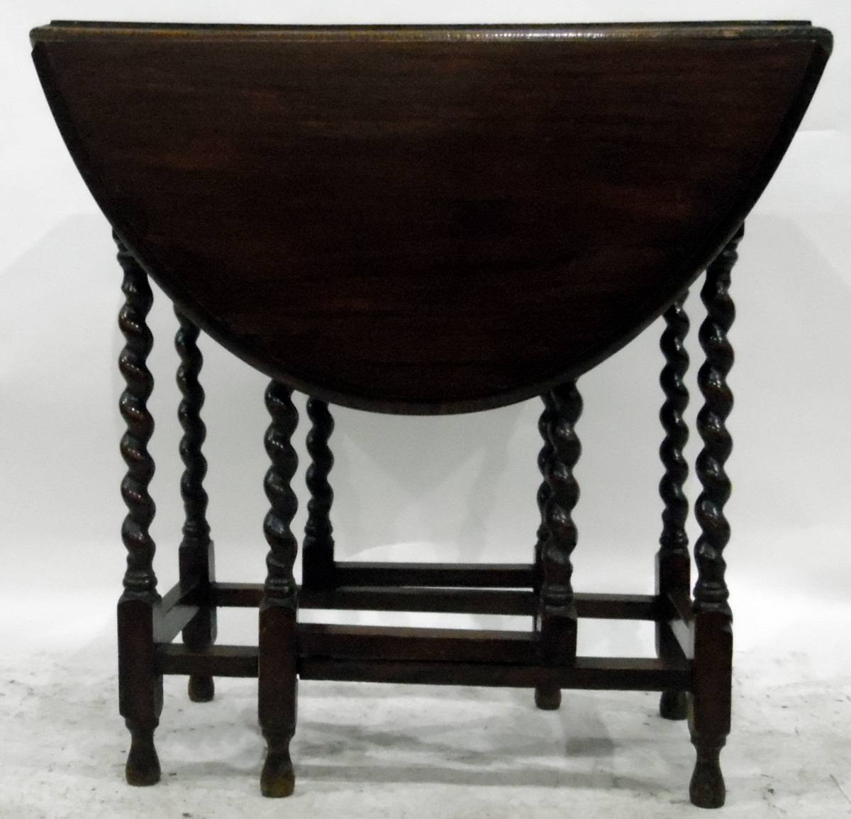Oak oval top gateleg table with moulded edge, on turned spiral supports united by stretchers,