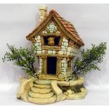 Pendelphin model of cottage with rabbit leaning out of top window, having detachable stepped base,