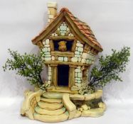 Pendelphin model of cottage with rabbit leaning out of top window, having detachable stepped base,