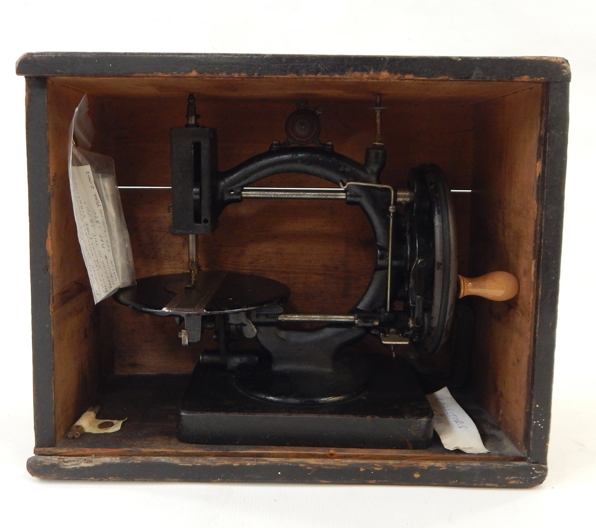 Late 19th century C-framed sewing machine, undecorated, with turned wood handle,