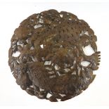 Decorative Haitian circular metal wall plaque with open fretwork bird and foliage design,