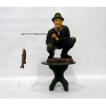 20th century ceramic painted crouching fisherman with rod and fish,