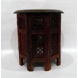 Eastern circular wooden occasional table with octagonal base, brass floral inlay,