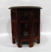 Eastern circular wooden occasional table with octagonal base, brass floral inlay,