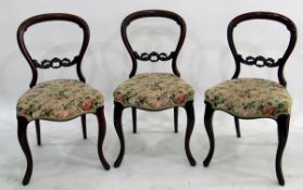 Set of four Victorian mahogany balloonback dining chairs with serpentine-fronted seats and foliate