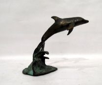 R Jones (20th century school) bronze model dolphin on verdigris bronze wave-pattern base,