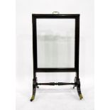 Georgian mahogany firescreen with glazed panel, on splayed legs with brass cap castors,