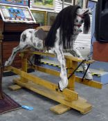 Dapple grey rocking horse, with horse hair mane and tail, mounted on a pine twin-pedestal support,