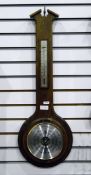 Aneroid barometer in an oak case, with silver temperature dial, by Day Master,