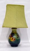 Moorcroft pottery table lamp, baluster-shaped with tube-lined decoration of various flowers,