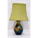 Moorcroft pottery table lamp, baluster-shaped with tube-lined decoration of various flowers,