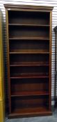 Mahogany open bookcase of six shelves, raised on a plinth base,