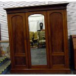 Victorian mahogany triple wardrobe with arched flame mahogany cross-banded panelled doors,