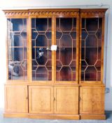 Yew wood veneer breakfront glazed bookcase, the astragal-glazed doors enclosing adjustable shelves,