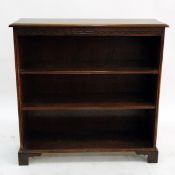 Oak open bookcase with moulded edged top, two adjustable shelves, raised on bracket feet,