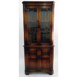 Georgian style oak double corner cupboard, the upper section with glazed leaded light panel doors,