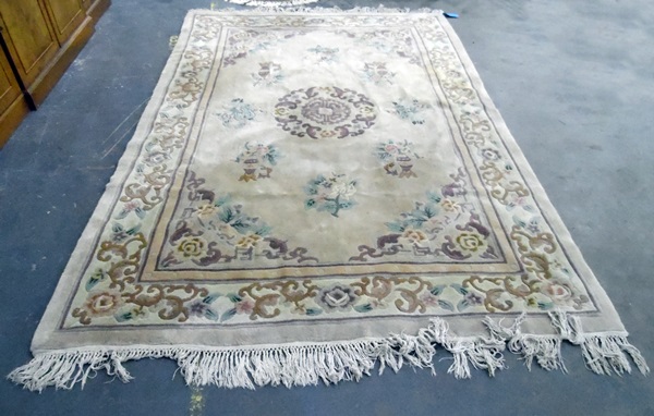 Large washed Chinese wool carpet, the ivory field with allover flowers and vases,