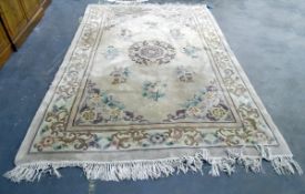 Large washed Chinese wool carpet, the ivory field with allover flowers and vases,