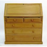 Modern oak bureau with fitted interior, two short and three long graduated drawers,