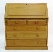Modern oak bureau with fitted interior, two short and three long graduated drawers,