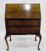 Queen Anne style walnut veneer bureau, the fall enclosing three short drawers,